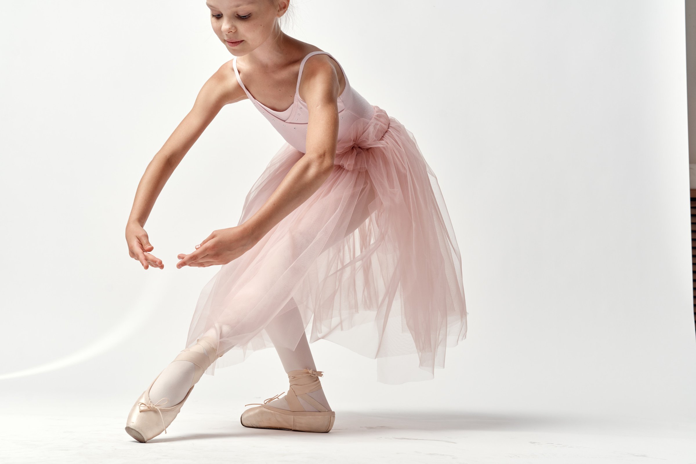 Girl Ballerina in Pink Dance Costume Ballet Dance Pointe Shoes Tutu Light Background Model