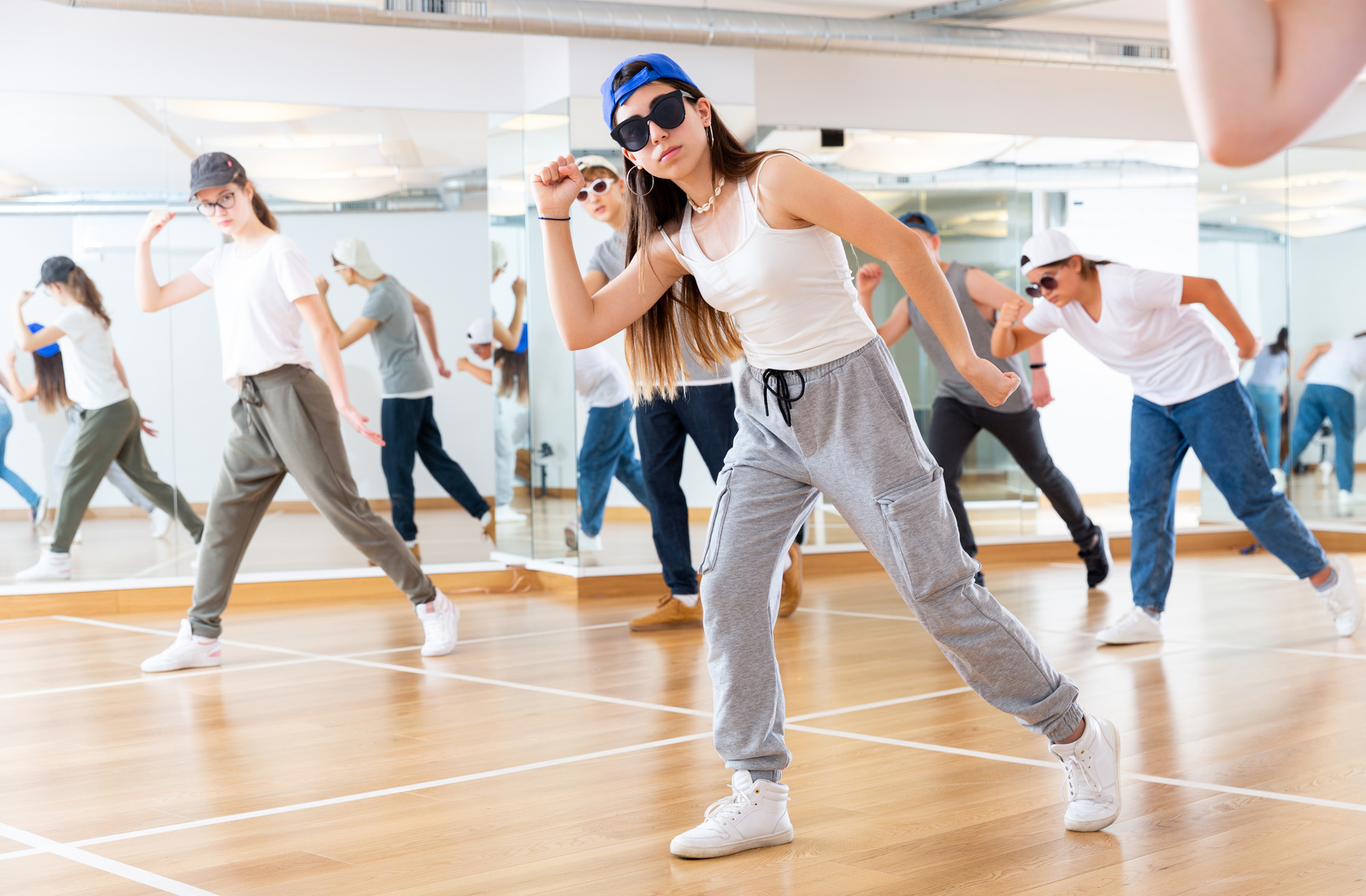 Teens dancing hip-hop dance together in dance hall